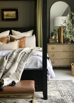 a bedroom with a canopy bed and pillows