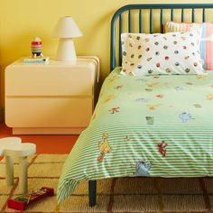 a child's bed with winnie the pooh comforter