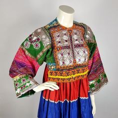 Beautiful handmade vintage Afghan Kuchi dress, richly decorated with traditional embroidery and beadwork. The dress is top of the dress is traditionally made of mixed materials; the skirt part of the dress is made of silk based fabric, which is soft to the skin and a pleasure to wear. This dress is about 50 years old and is handmade with lots of love, patience and skill. Although the dress is in excellent condition, signs of wear, a (moth) hole, a small damage or/and a stain are possible. Despit Traditional Multicolor Embroidered Long Sleeve Dress, Folk Style Embroidered Transitional Dresses, Multicolor Long Sleeve Embroidered Dress For Festive Occasions, Embellished Dresses For Traditional Ceremonies And Festivals, Traditional Embellished Embroidered Festive Dress, Traditional Festive Embellished Embroidered Dress, Transitional Multicolor Embroidered Dresses, Transitional Season Embroidered Multicolor Dresses, Multicolor Folk Style Ceremonial Dress