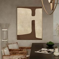 a dining room table with chairs and a painting hanging on the wall above it's head