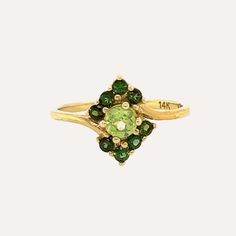 We took inspiration from Cimorene, the princess of Dealing with Dragons to name this beautiful ring made of carefully selected green peridot stones in different tones. A main stone adorned with six small darker toned peridot stones make this piece truly special. Green Peridot is believed to bring good health, restful sleep and peace to relationships. Formal Green Multi-stone Sapphire Ring, Green Multi-stone Oval Diamond Ring, Green Oval Multi-stone Diamond Ring, Oval Green Multi-stone Diamond Ring, Yellow Gold Peridot Rings With Gemstone Accents, Green Emerald Cut Multi-stone Diamond Ring, Emerald Cut Green Multi-stone Ring, Emerald Cut Green Multi-stone Diamond Ring, Green Birthstone Ring Fine Jewelry