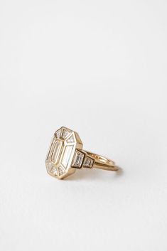 an antique diamond ring on a white background