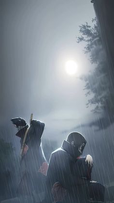 two people sitting on a bench in the rain