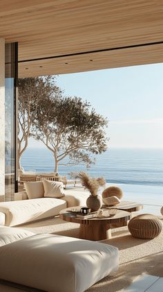 a living room filled with furniture next to the ocean