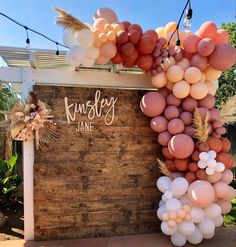 balloons are hanging from the side of a wooden sign that reads,'happy jane '