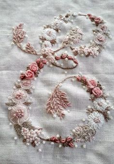 two pieces of embroidered fabric with flowers on them