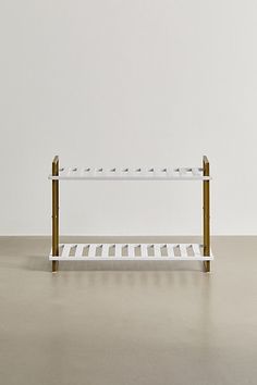 a white and gold shelf sitting on top of a floor