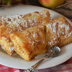 two pieces of apple pie on a white plate