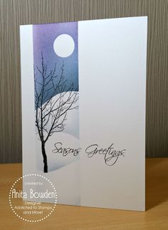 a greeting card with a tree in the snow on top of it, and an image of a full moon