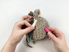 someone is crocheting something in a small bag