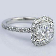 a cushion cut diamond ring with pave set shoulders