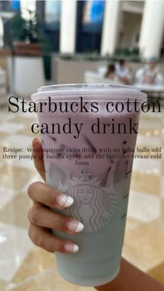 someone holding up a starbucks cup with the words starbucks's cotton candy drink