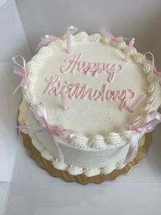 a white cake with pink lettering on it