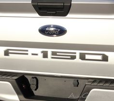 the front end of a white ford f - 150 pickup truck