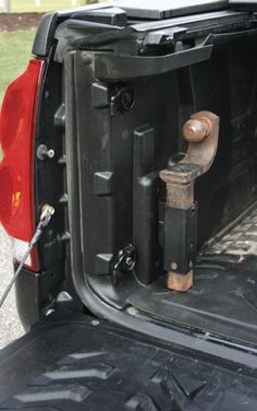 the back end of a vehicle with its trunk open and tools in it's compartment