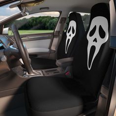 the interior of a car with two halloween themed seats