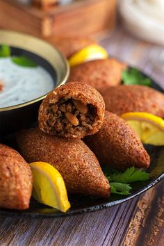 some food that is on a plate with lemons and other foods in the background