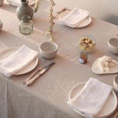 the table is set with dishes and silverware