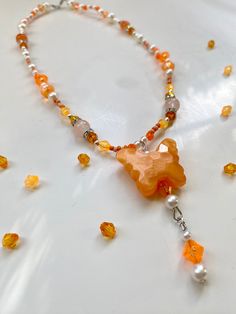 The Chroma Collection features 6 different necklaces! This necklace is adorned in a beautiful  collection of orange, white, and silver beads. it features a lovely hanging butterfly charm. All of my beaded necklaces are assembled by hand with love and are designed to be a unique look for whoever wears it! Art and beauty is for everyone. Thank you for visiting my garden. <3 Luxury Orange Spiritual Beaded Necklace, Luxury Spiritual Orange Beaded Necklace, Orange And Purple Jewerly Beads, Orange Beaded Necklaces With Lobster Clasp, Orange Beaded Dangle Necklaces, Orange Beaded Pendant Necklace, Butterfly Charm Necklaces With Round Beads For Gifts, Butterfly Charm Necklace With Round Beads For Gift, Orange Beaded Spiritual Crystal Necklace