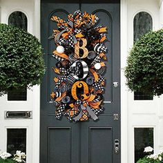 the front door is decorated with orange and black decorations