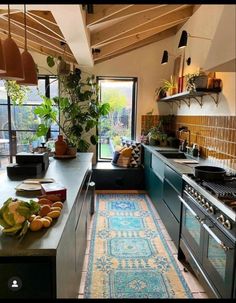 a kitchen with an area rug on the floor next to the sink and stove top