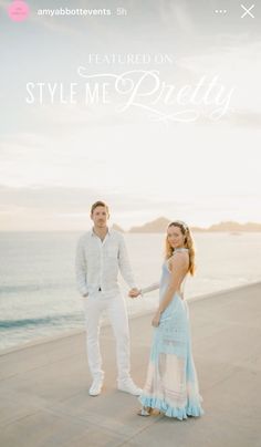 a man and woman standing next to each other near the ocean