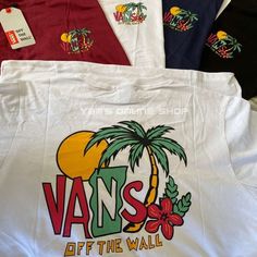 various vans t - shirts are on display in a row, including one with palm trees and the word vans off the wall