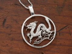 This Sterling Silver Dragon Pendant was Hand Cut using a Silver medallion I found years ago. The Dragon has a Classic look and has  great detail. This is the largest Dragon we do in our line and measures 1 3/8" in Diameter so is more appropriate for someone looking for a larger pendant or a person with a larger frame. The Pendant comes with a Sterling Silver Box Chain that is available in four different lengths. Cut Coin Jewelry, Palm Tree Pendant, Silver Dragon Necklace, Zodiac Pendant Necklace, Dragon Necklace, Dragon Jewelry, Zodiac Pendant, Silver Dragon, Dragon Pendant