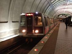 a train traveling through a subway station next to a platform