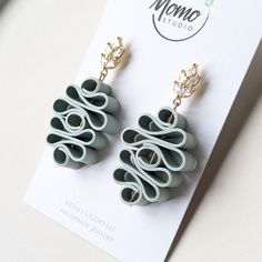 a pair of earrings sitting on top of a card