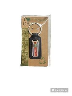 a key chain with a bottle opener in it's packaging bag on a white background