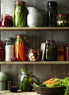 many jars filled with different types of vegetables