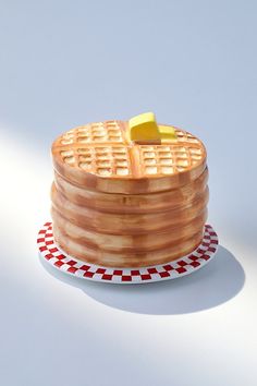 a stack of waffles sitting on top of a red and white checkered plate