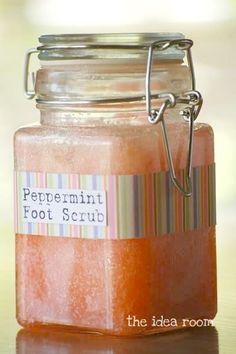 a glass jar filled with orange liquid on top of a wooden table next to a facebook page