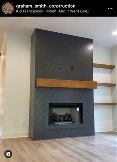 an empty room with a fireplace and shelves