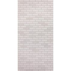 a white brick wall with a light gray floor and rug on the bottom right corner