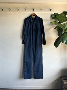 Awesome Vintage 1970s Universal Overall Co Stone Cutter Unionmade Zip Up Coveralls. Navy blue in color made from a cotton/poly fiber blend. Coveralls have a zip up front closure with a front 4 pocket design. Crispy and very clean. Condition overall is excellent with no noted flaws. No rips, tears, or staining. Please see all photos for details. Refer to measurements below to ensure a proper fit 24" pit to pit 20" shoulder to shoulder  25" sleeves 20" waist (40) 23" across hip 33" inseam Fitted Cotton Denim Jumpsuit With Side Pockets, Full-length Cotton Denim Jumpsuit With Pockets, Cotton Overalls With Slip Pockets For Workwear, Cotton Workwear Overalls With Slip Pockets, Full-length Blue Cotton Denim Jumpsuit, Vintage Cotton Jumpsuits And Rompers For Work, Blue Full-length Cotton Denim Jumpsuit, Blue Full-length Cotton Overalls, Blue Cotton Full-length Denim Jumpsuit