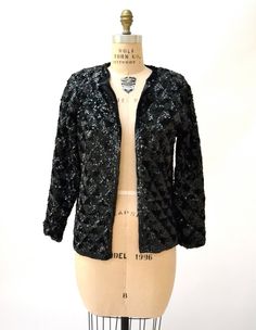 "Amazing Vintage Sequin Jacket Features: * fully embellished with black onyx sequins on wool body with woven lining * Basic neckline with long sleeves * Relaxed fit * great statement piece * Black lining and front hook and eye closure No Brand Sweater knit wool with synthetic lining Size 40, Fits like a Medium Era most likely the 50/60s In great condition, Beautiful jacket! Bust 40\" Bottom opening 39\" Body length from Shoulder seam 24\" Sleeve length from neck seam 27\" (can be taken out 1\") Winter Embellished Long Sleeve Blazer, Glamorous Evening Cardigan For Winter, Glamorous Evening Winter Cardigan, Winter Party Embellished Outerwear, Winter Embellished Black Blazer, Winter Black Embellished Blazer, Black Embellished Winter Outerwear, Embellished Black Blazer For Fall, Black Embellished Fall Blazer