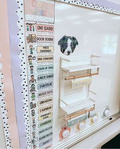 a dog is looking over the top of a refrigerator with magnets on it's side