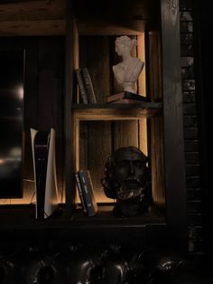 a book shelf with books and a busturine on it