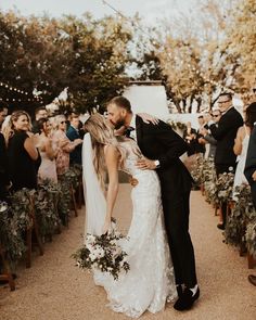 a bride and groom kissing at their wedding ceremony