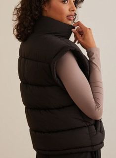 Stay cozy and stylish with this oversized puffer vest, perfect for layering during transitional weather. Featuring a full zipper for customizable coverage and two front pockets for convenient storage, this vest is both functional and fashionable. Fit: Relaxed Closure: Zipper Material: 100% Polyester Sleeveless Oversized Puffer Vest, Oversized Puffer, Stay Cozy, Puffer Vest, Puffer, Layering, Zipper, Black