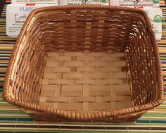 a wicker basket sitting on top of a table next to some carton boxes