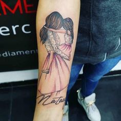 a woman's arm with a tattoo on it that has a drawing of two people hugging