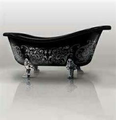 an old fashioned bathtub with ornate designs on the body and feet is shown in black