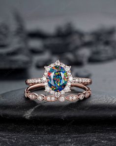 an engagement ring with a rainbow colored diamond in the center