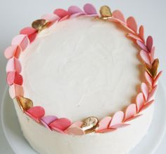 a cake decorated with pink and gold leaves