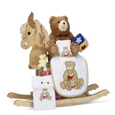 two stuffed animals sitting on top of a rocking horse