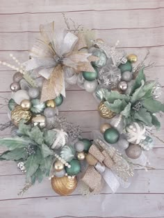 a christmas wreath with ornaments and greenery