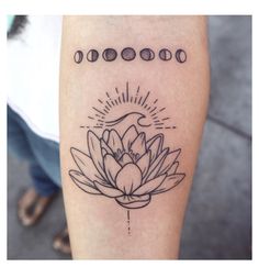 a lotus tattoo on the right arm with five phases in front of it and an arrow at the center